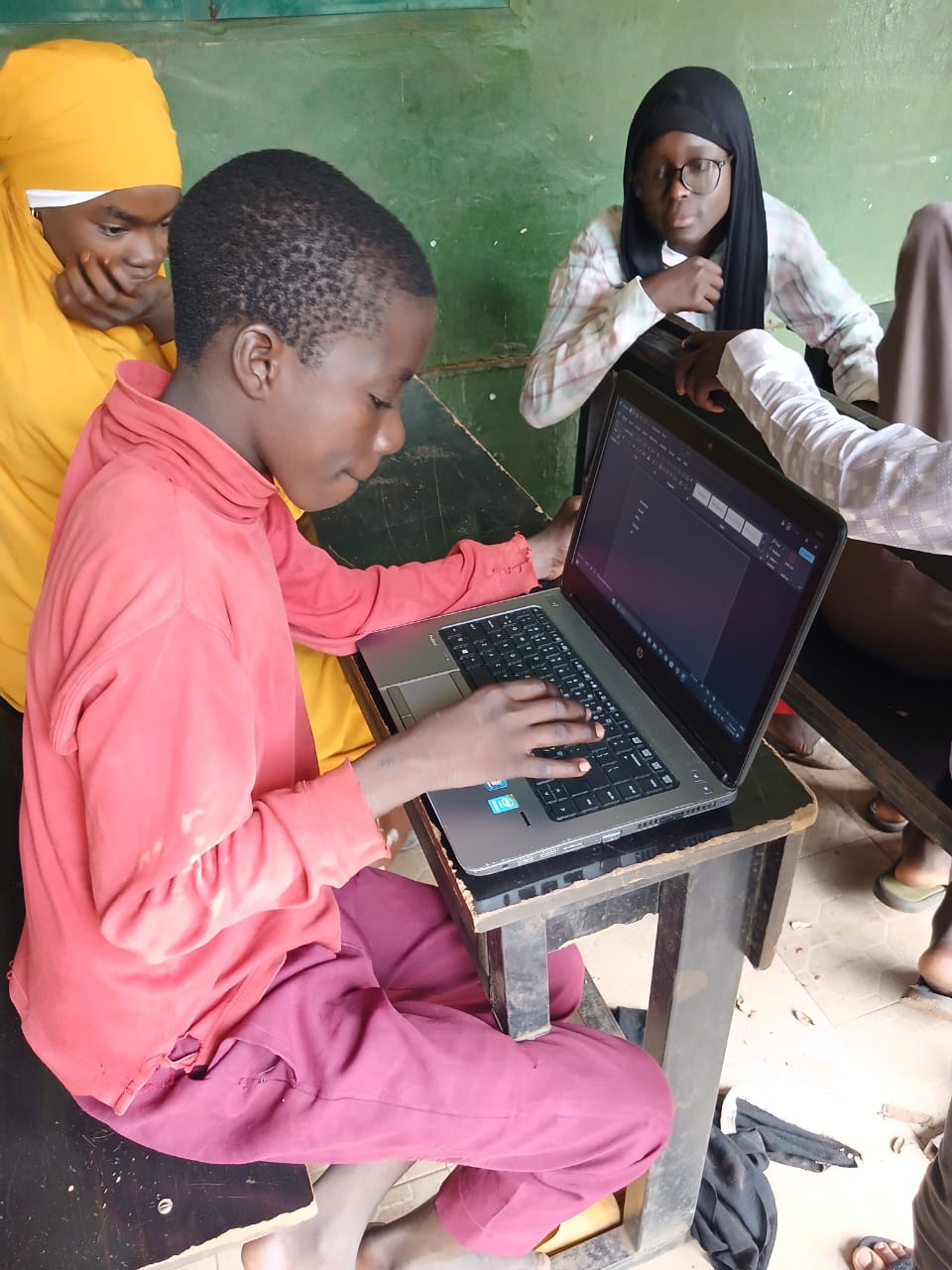 A child learning on a laptop at the Orphanage Outreach